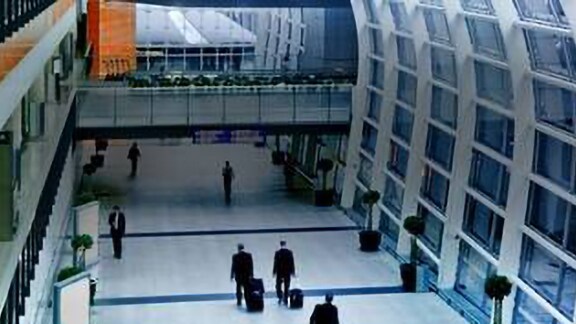 Interior top view of people walking in a airport hallway