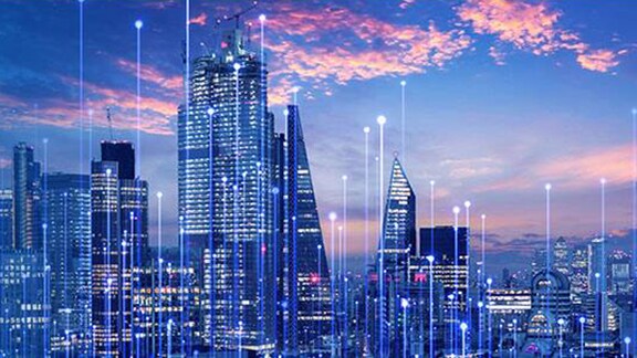 Night view of city sky scrappers in blue overlaid with graphics of transmission nodes