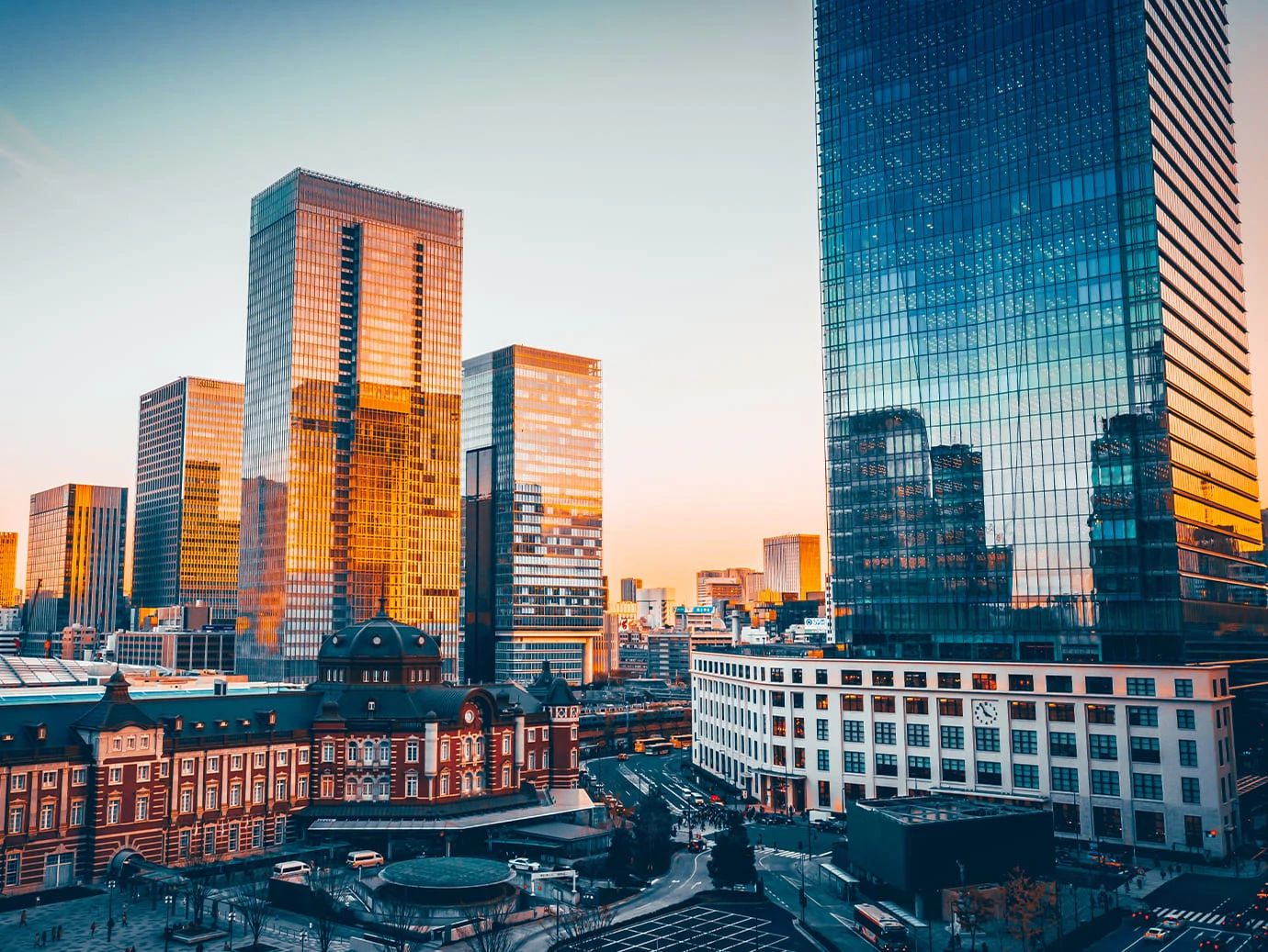 View of the Shin-Marunouchi Building including the other neighborhood buildings in the evening sunlight