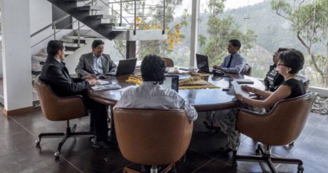 Employees in a meeting sitting around a table