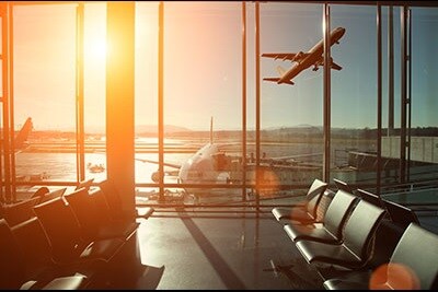 Airplane flying seen from other side of a airport