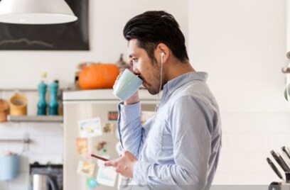 Man drinking in kitchen