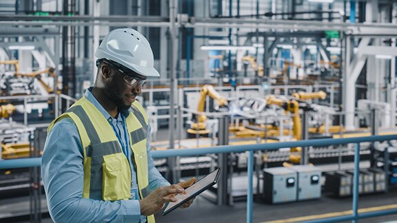 A maintenance worker scrolling on a tablet