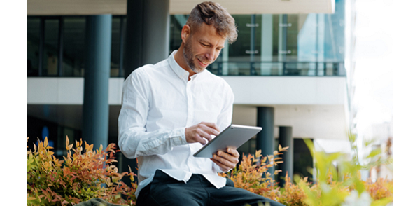 Man sitting and using his tablet
