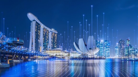 A metropolitan skyline at dusk, overlaid with OpenBlue graphics