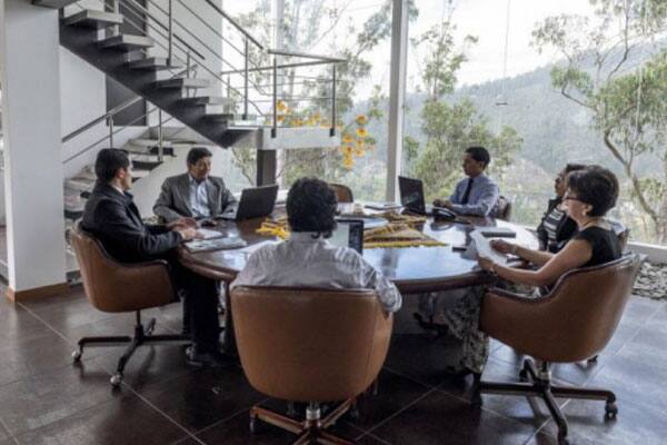 Employees in a meeting sitting around a table