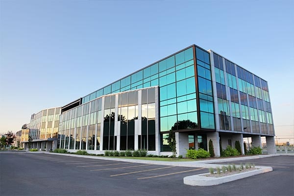 Exteriors of a modern office building with floor length glass windows