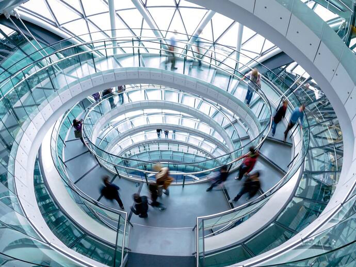 Time lapse of the people getting down the spiral stairs of a London city hall building